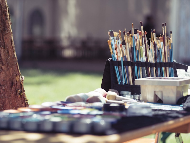 Woman watering plants with garden hose in yard