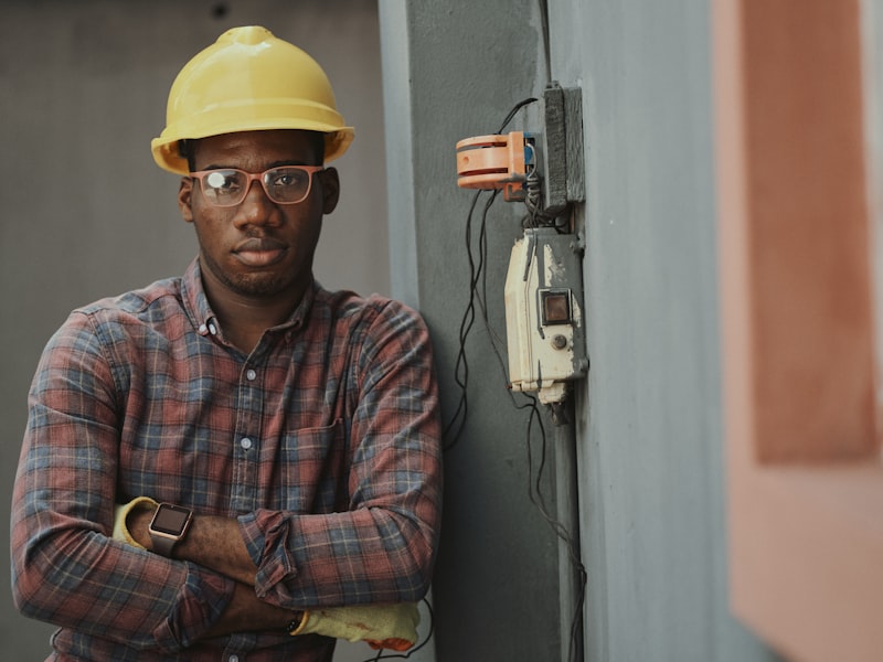 Handyman with toolbelt fixing shelves on wall