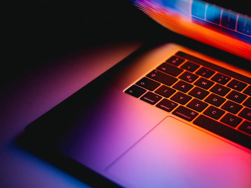 Laptop on cafe table with espresso and notebook