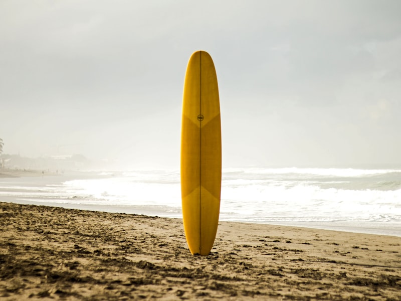 Person standing on paddleboard at sunset